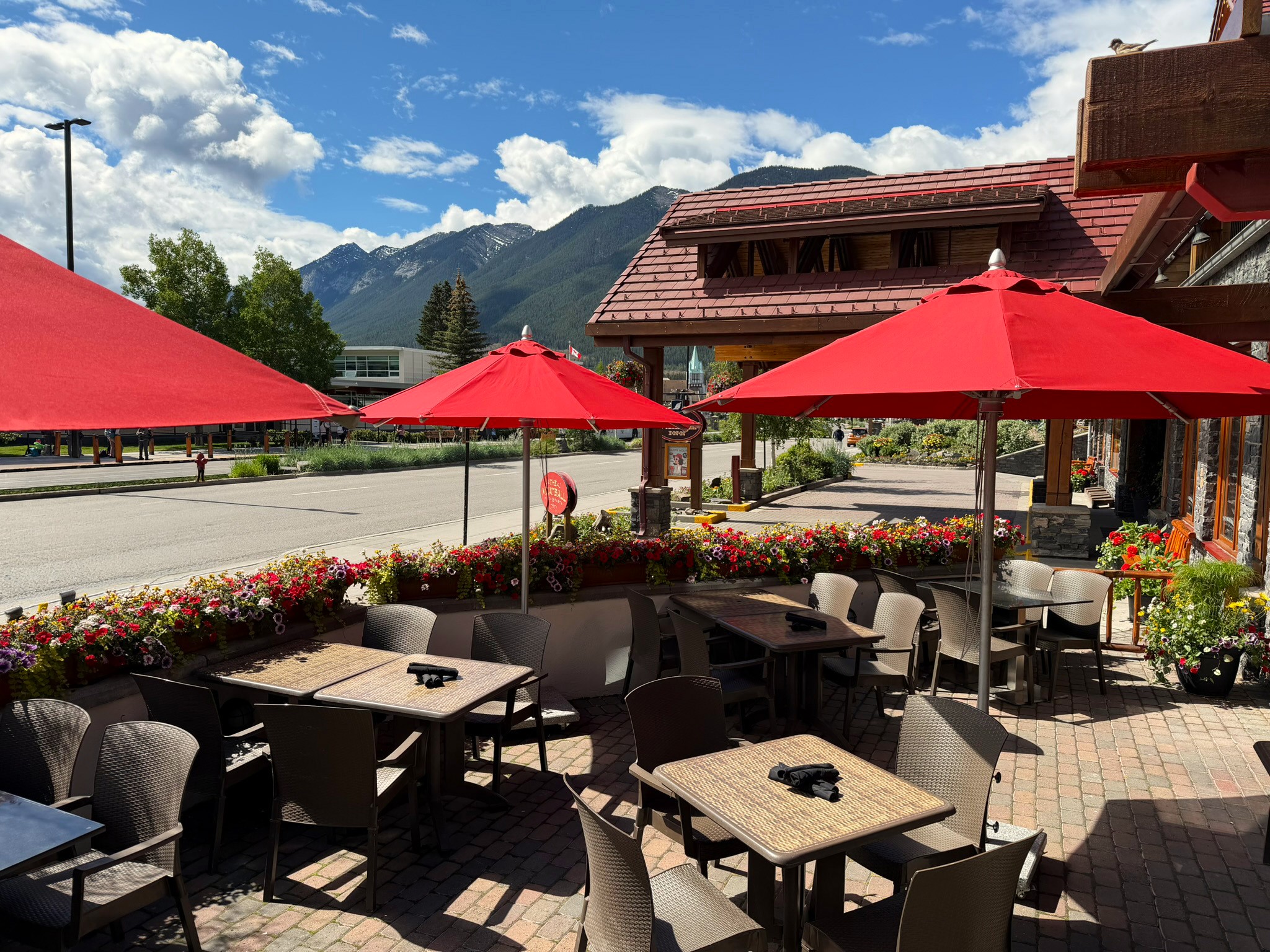 The Meatball Patio with blue skies, mountain views and red umbrellas
